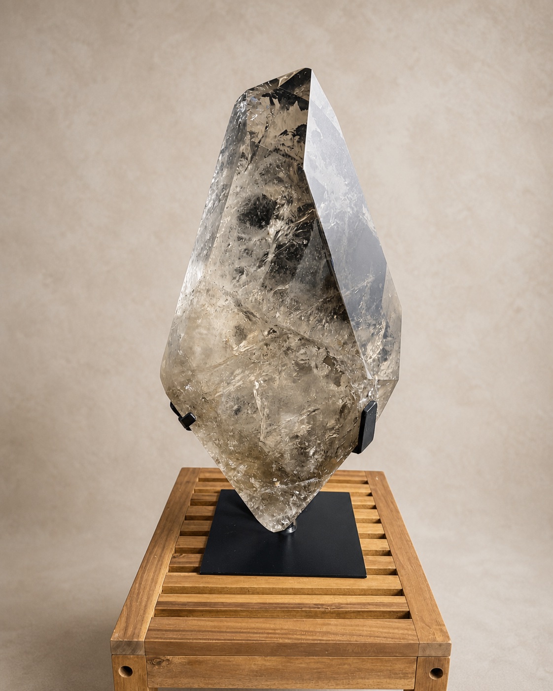 Front documentary view of the monumental pale smoky quartz sculpture