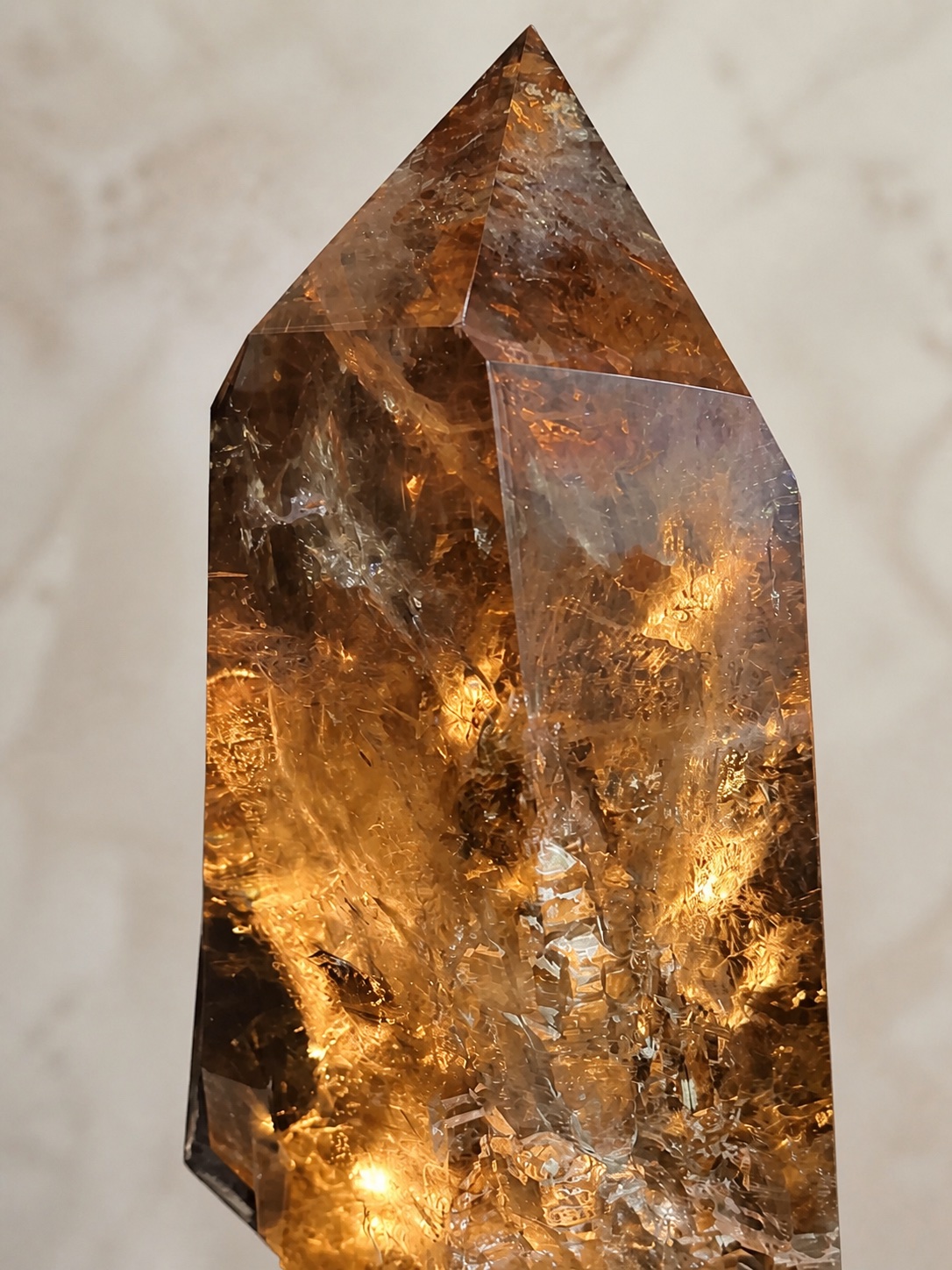 Close detail of the warm smoky quartz facets and inclusions