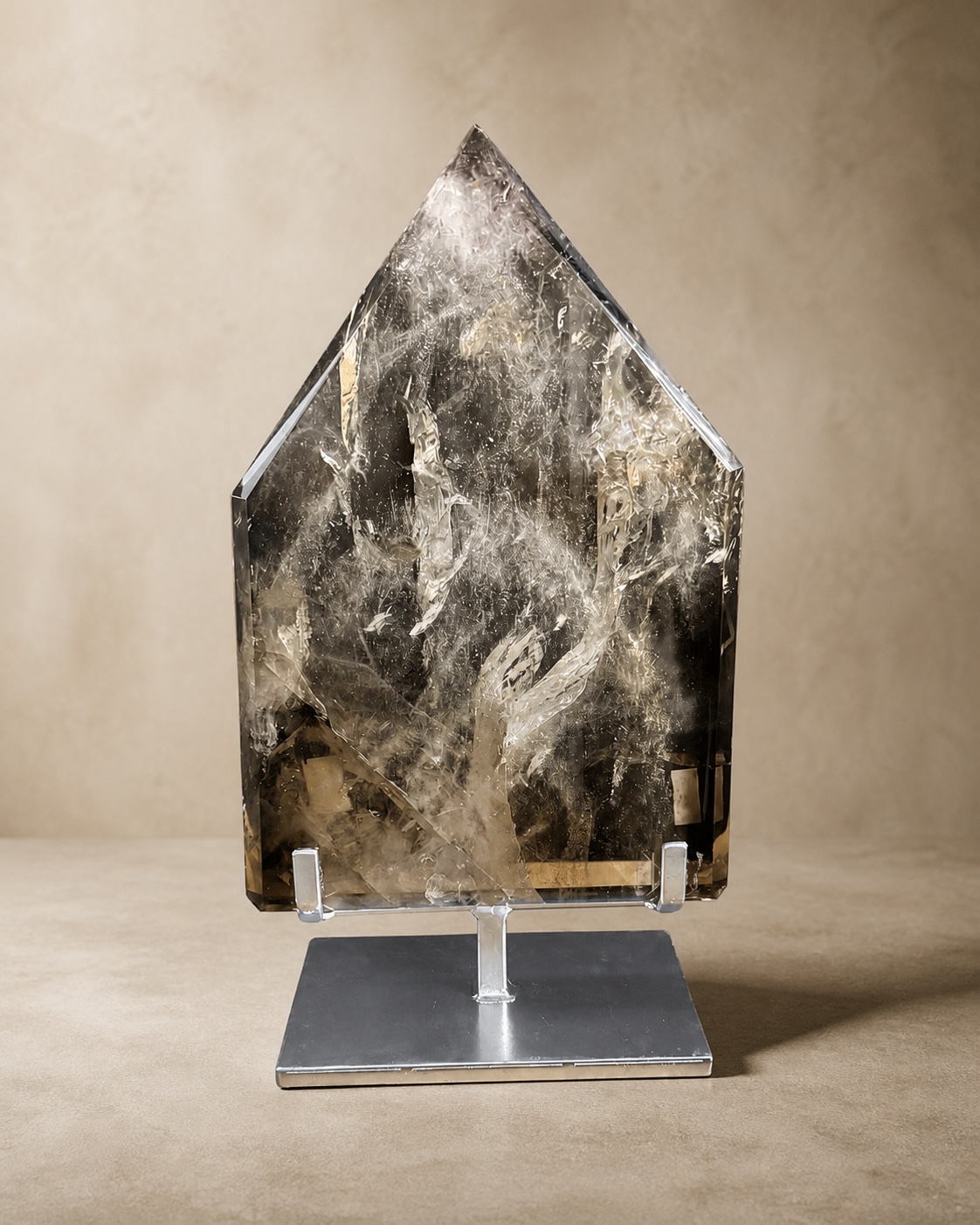 Front documentary view of the broad smoky quartz shield sculpture
