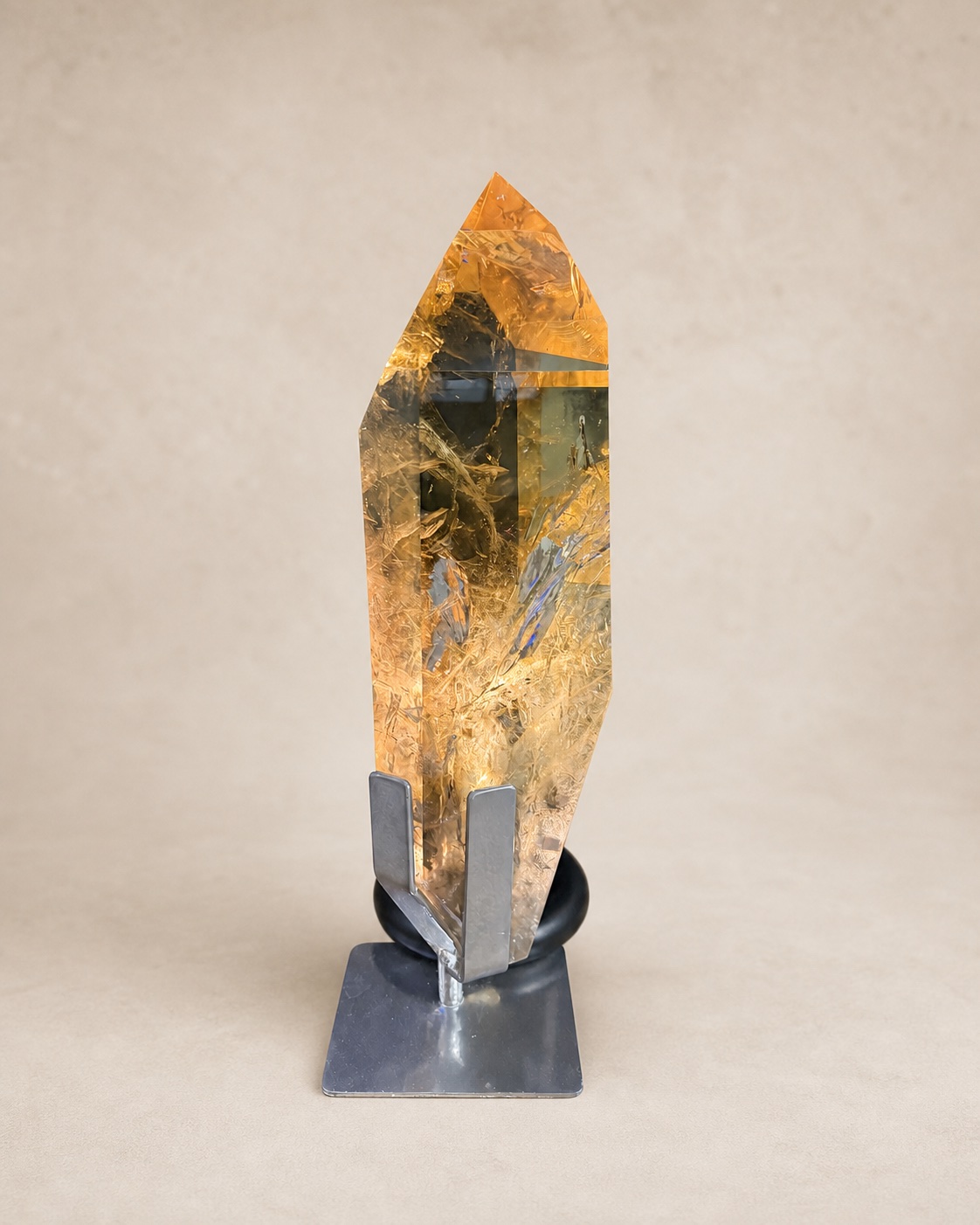 Front documentary view of the warm-toned elongated quartz point